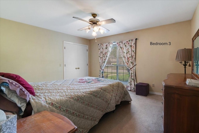 carpeted bedroom with baseboards and a ceiling fan