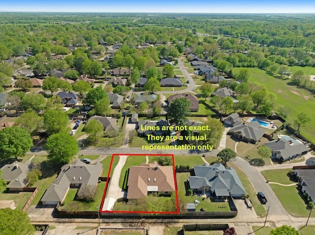 bird's eye view featuring a forest view and a residential view
