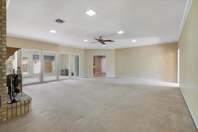 unfurnished living room with crown molding, visible vents, and carpet flooring