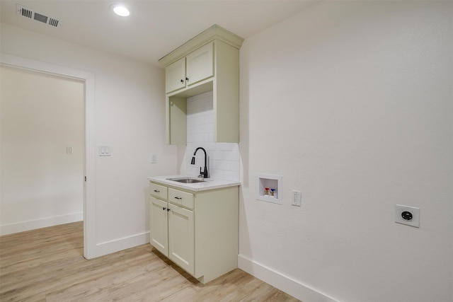 5440 Fursman Ave, Fort Worth, TX 76114 - laundry room with visible vents, hookup for an electric dryer, washer hookup, a sink, and light wood finished floors