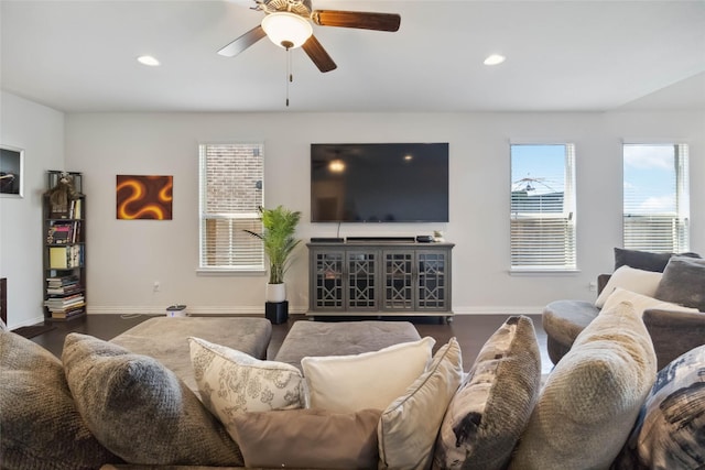 living room featuring baseboards, a ceiling fan, and recessed lighting