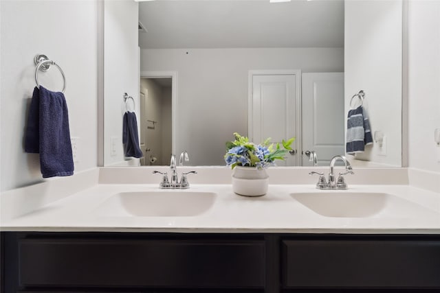 bathroom featuring a sink and double vanity