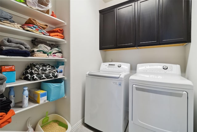 clothes washing area with cabinet space and washing machine and clothes dryer