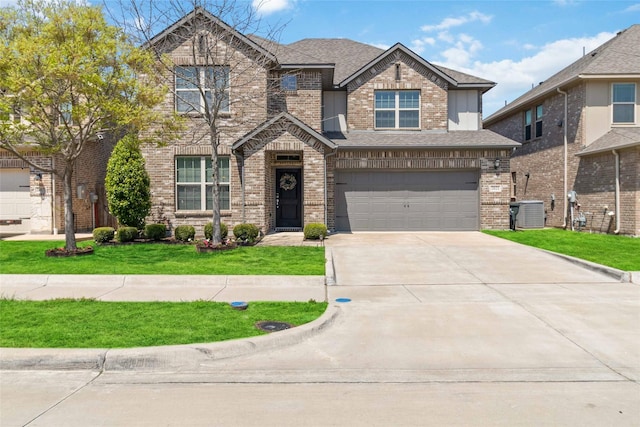 craftsman-style house featuring a garage, a front yard, brick siding, and driveway