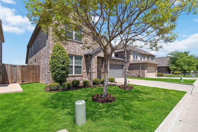 traditional home featuring brick siding, a front lawn, a garage, and driveway