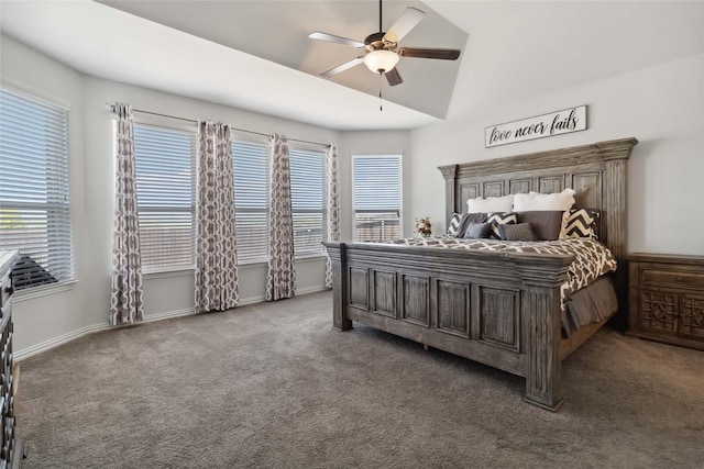 carpeted bedroom with a ceiling fan, baseboards, multiple windows, and lofted ceiling