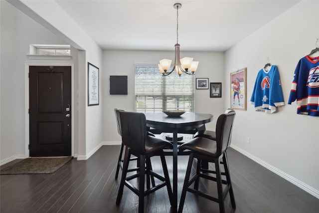 dining space with a chandelier, dark wood-style flooring, and baseboards