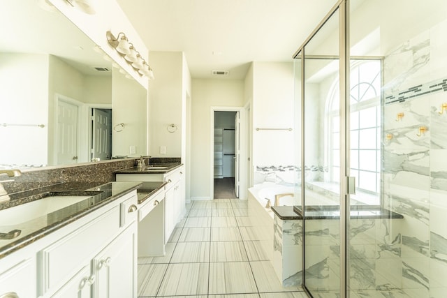 full bath featuring a sink, visible vents, a shower stall, and a garden tub