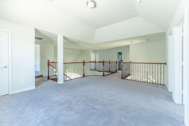 additional living space with visible vents, carpet, and vaulted ceiling
