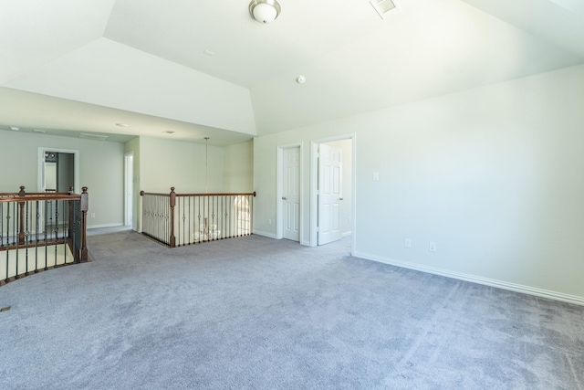 empty room featuring high vaulted ceiling, visible vents, baseboards, and carpet floors