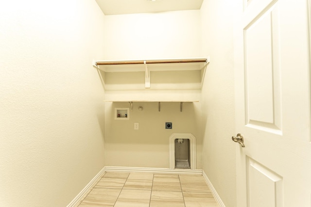 clothes washing area featuring baseboards, washer hookup, hookup for a gas dryer, laundry area, and hookup for an electric dryer