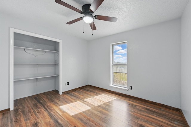 2306 Lavon Creek Ln, Arlington, TX 76006 - unfurnished bedroom featuring a closet, baseboards, a ceiling fan, and wood finished floors