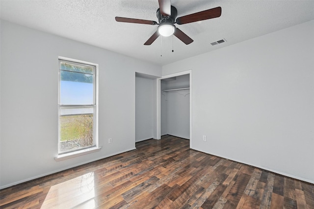 2306 Lavon Creek Ln, Arlington, TX 76006 - unfurnished bedroom with dark wood-type flooring, visible vents, a closet, and a ceiling fan
