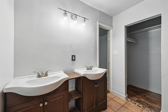 2306 Lavon Creek Ln, Arlington, TX 76006 - bathroom featuring two vanities, a sink, tile patterned flooring, and a spacious closet