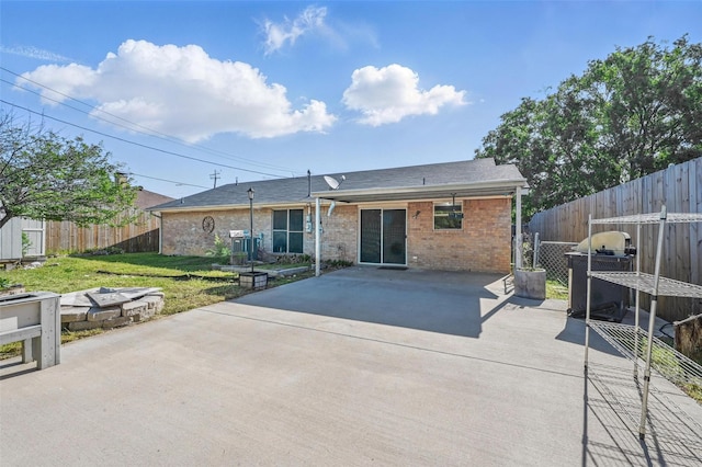 2306 Lavon Creek Ln, Arlington, TX 76006 - rear view of property featuring a patio, brick siding, a fenced backyard, and a yard