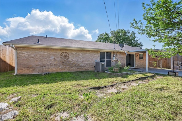 2306 Lavon Creek Ln, Arlington, TX 76006 - back of property with brick siding, fence, cooling unit, and a lawn