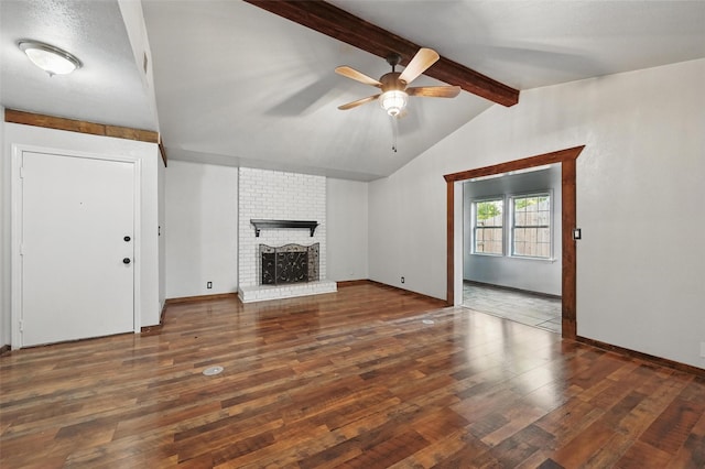 2306 Lavon Creek Ln, Arlington, TX 76006 - unfurnished living room featuring ceiling fan, lofted ceiling with beams, wood finished floors, a brick fireplace, and baseboards
