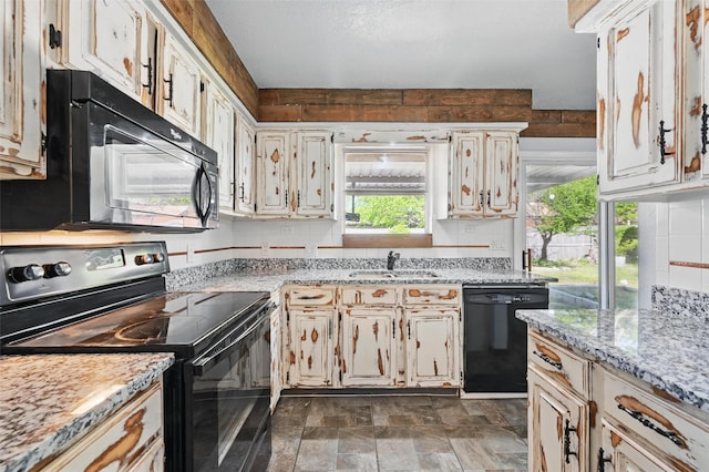 2306 Lavon Creek Ln, Arlington, TX 76006 - kitchen featuring stone finish flooring, light stone countertops, a sink, and black appliances