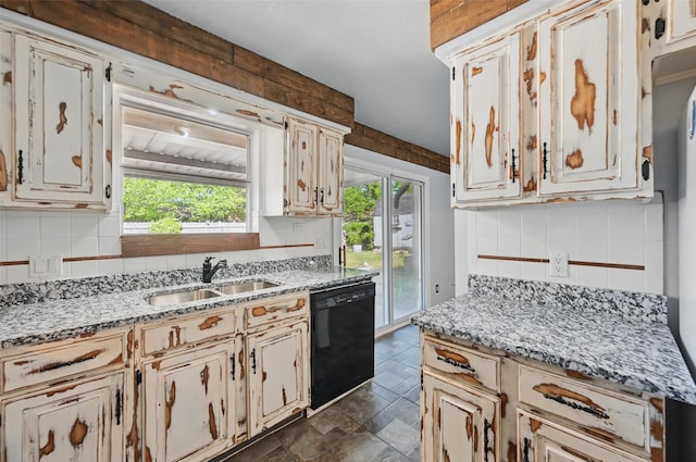 2306 Lavon Creek Ln, Arlington, TX 76006 - kitchen featuring stone finish floor, light stone counters, dishwasher, a sink, and backsplash