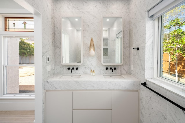 4416 Livingston Ave, Highland Park, TX 75205 - bathroom with a sink, double vanity, and tile walls