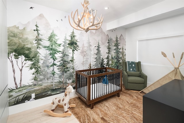 4416 Livingston Ave, Highland Park, TX 75205 - bedroom with recessed lighting, a nursery area, a notable chandelier, and wood finished floors