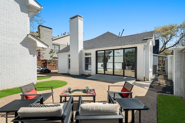 4416 Livingston Ave, Highland Park, TX 75205 - back of property featuring a chimney, brick siding, fence, a patio, and a shingled roof