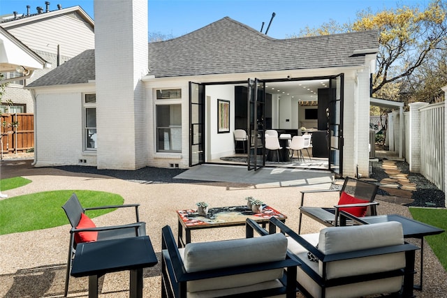 4416 Livingston Ave, Highland Park, TX 75205 - back of property with a patio, a chimney, a fenced backyard, brick siding, and roof with shingles