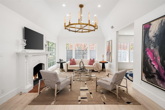 4416 Livingston Ave, Highland Park, TX 75205 - living area with wood finished floors, a warm lit fireplace, a healthy amount of sunlight, and a notable chandelier