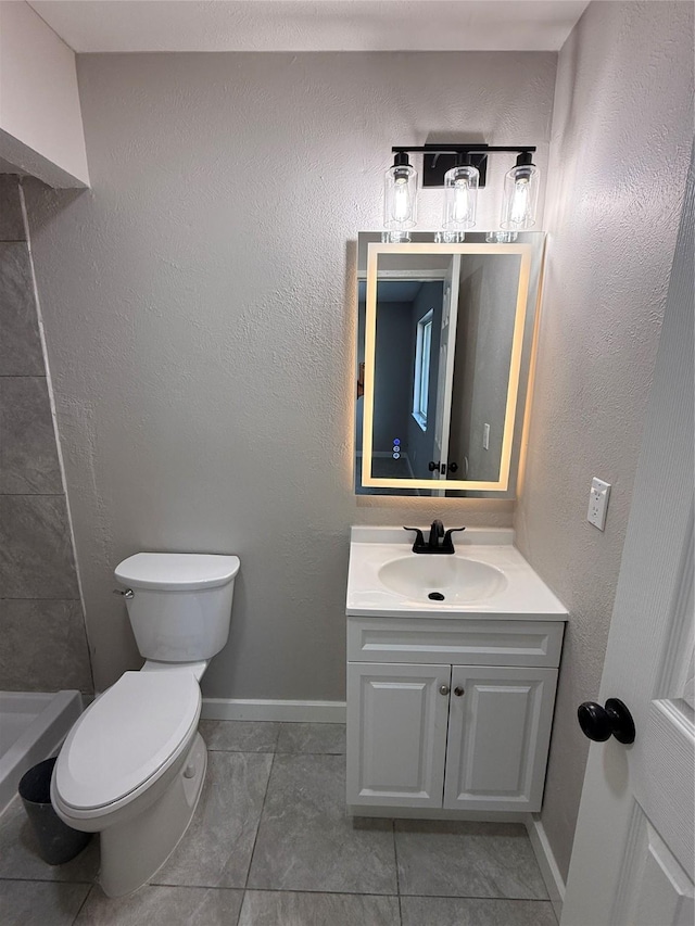 5540 Rutledge Dr, The Colony, TX 75056 - bathroom featuring toilet, tile patterned floors, vanity, and baseboards