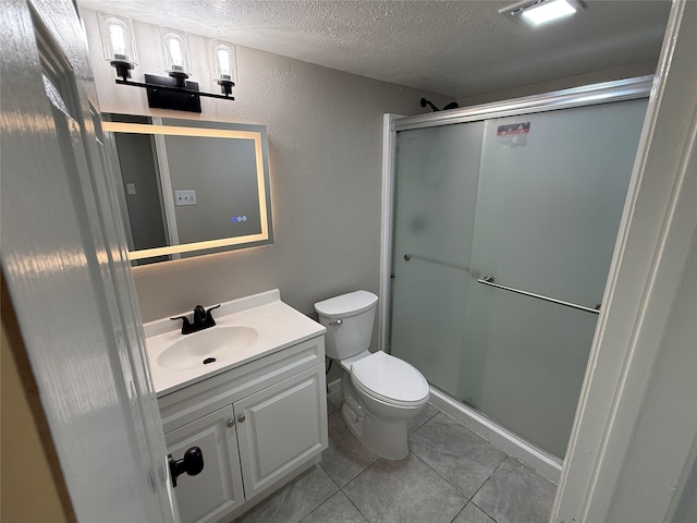 5540 Rutledge Dr, The Colony, TX 75056 - bathroom featuring tile patterned flooring, a shower stall, toilet, vanity, and a textured ceiling