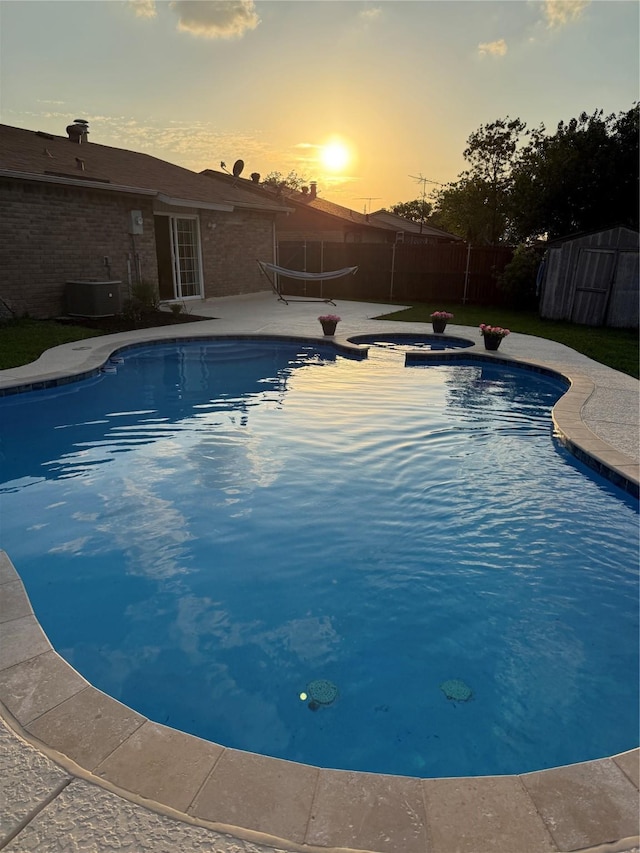 5540 Rutledge Dr, The Colony, TX 75056 - view of swimming pool featuring central air condition unit, a fenced in pool, and a fenced backyard