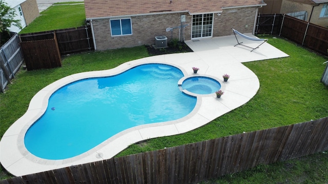 5540 Rutledge Dr, The Colony, TX 75056 - view of swimming pool with a fenced backyard, a yard, a patio, a pool with connected hot tub, and central AC