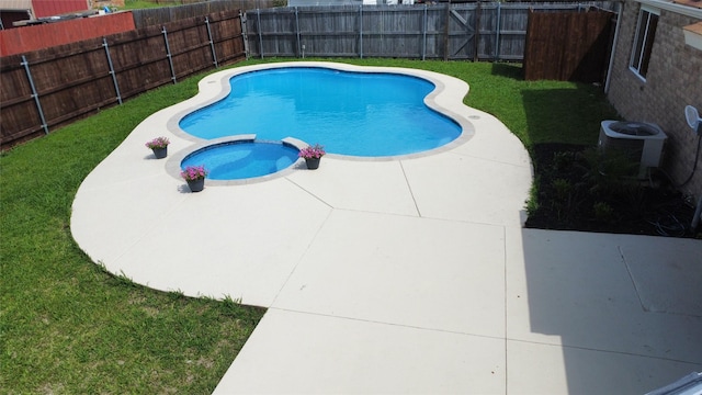 5540 Rutledge Dr, The Colony, TX 75056 - view of swimming pool featuring a patio, a pool with connected hot tub, central AC unit, a fenced backyard, and a lawn