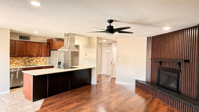5540 Rutledge Dr, The Colony, TX 75056 - kitchen featuring appliances with stainless steel finishes, visible vents, light countertops, exhaust hood, and a ceiling fan