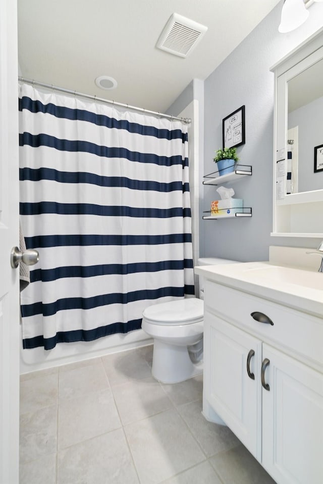 full bathroom with a shower with curtain, vanity, toilet, visible vents, and tile patterned flooring