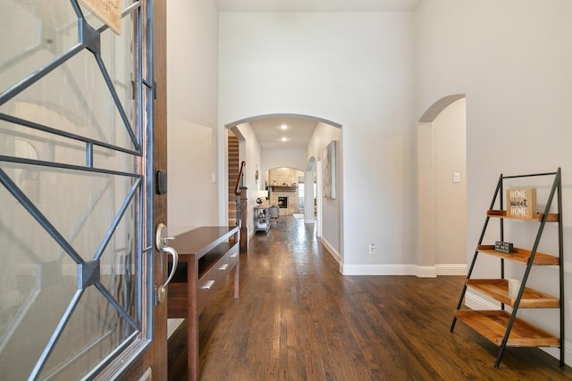 745 Sandbox Dr, Little Elm, TX 76227 - foyer featuring wood finished floors, arched walkways, baseboards, and a high ceiling