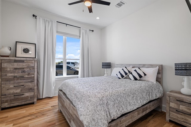 bedroom with ceiling fan, wood finished floors, visible vents, and recessed lighting