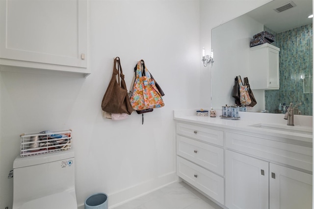 bathroom featuring a tile shower, baseboards, visible vents, marble finish floor, and vanity