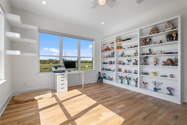 unfurnished office featuring recessed lighting, light wood-style floors, a ceiling fan, and baseboards