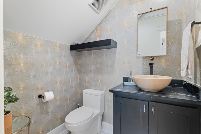 bathroom with vanity, visible vents, toilet, and lofted ceiling