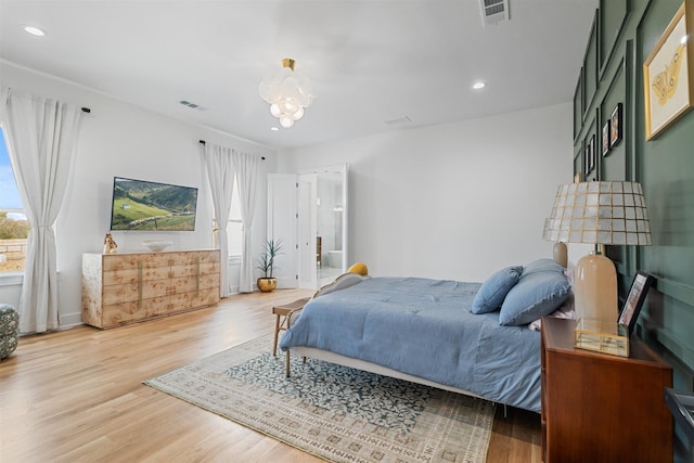 bedroom with a chandelier, visible vents, recessed lighting, and light wood-style floors