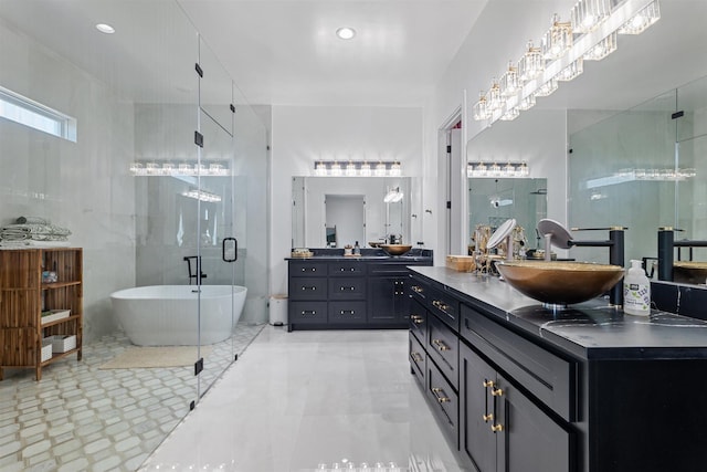 bathroom with a shower stall, a freestanding bath, vanity, and marble finish floor