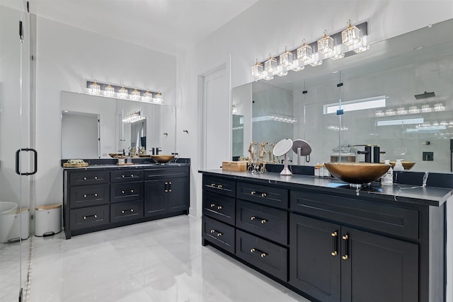 bathroom featuring two vanities, marble finish floor, a sink, and a shower stall