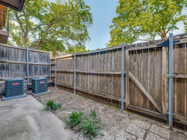 view of yard with a patio, central AC unit, and a fenced backyard