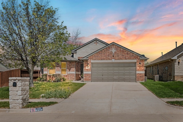 ranch-style home featuring a garage, brick siding, fence, and concrete driveway