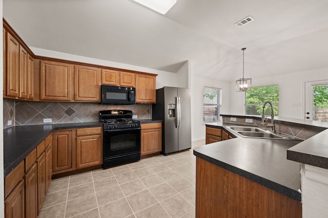 kitchen featuring visible vents, a sink, black appliances, and dark countertops