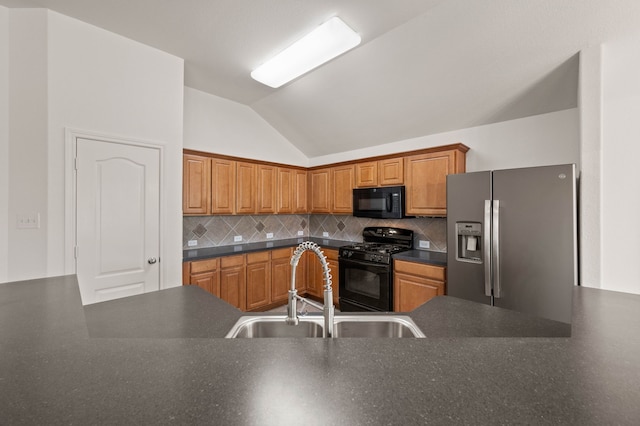 kitchen with tasteful backsplash, black appliances, a sink, dark countertops, and lofted ceiling