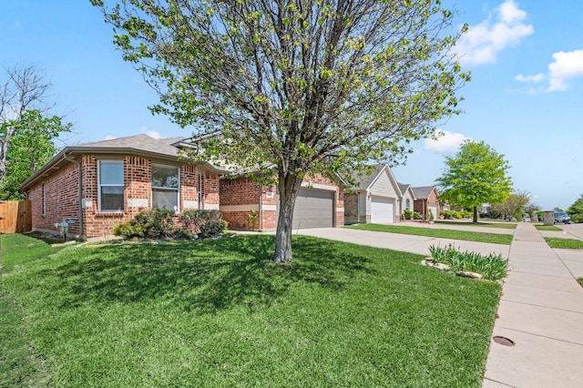 single story home with fence, a front lawn, brick siding, an attached garage, and concrete driveway