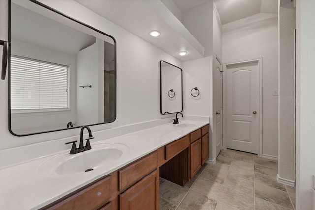 bathroom with tile patterned floors, double vanity, and a sink