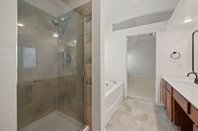 full bathroom featuring a shower stall, a bath, vanity, and tile patterned floors
